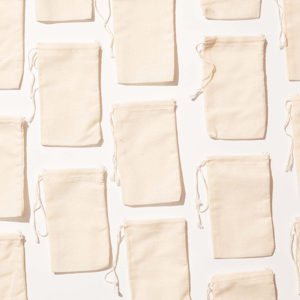 A fill-your-own drawstring muslin bag. Made from virgin (unbleached) cotton fabric (off-white), woven domestically There are no toxic chemicals used in the weaving process of these bags. Meets requirements for use in food applications.